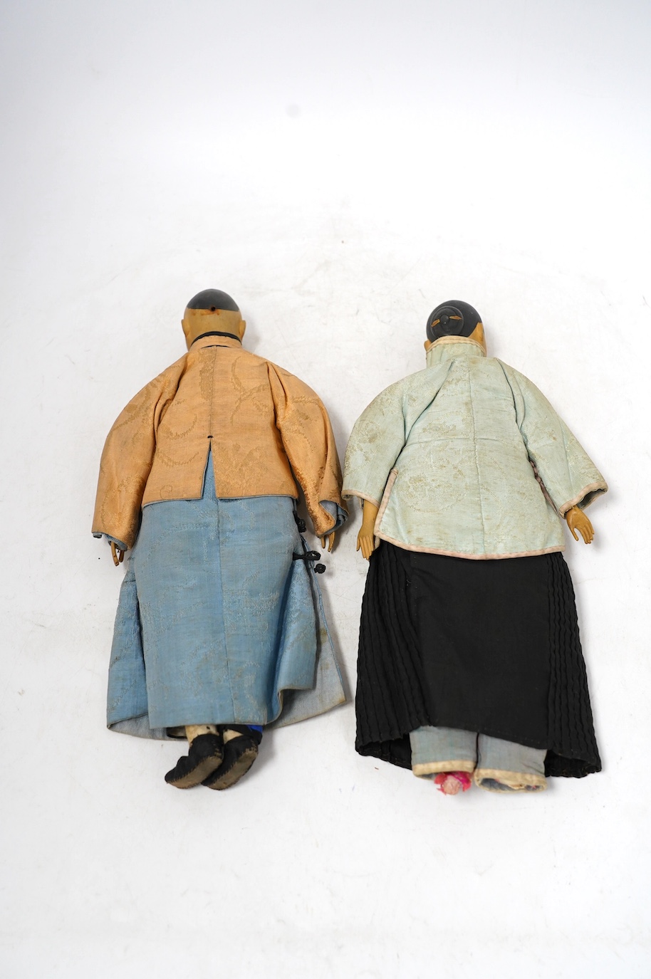 Two Chinese Door of Hope missionary wood and fabric dolls, early 20th century, 30cm, and a Chinese soapstone figure of Guanyin, 18th/19th century, 10.5cm. Condition - fair, feet missing to one and other minor wear etc.